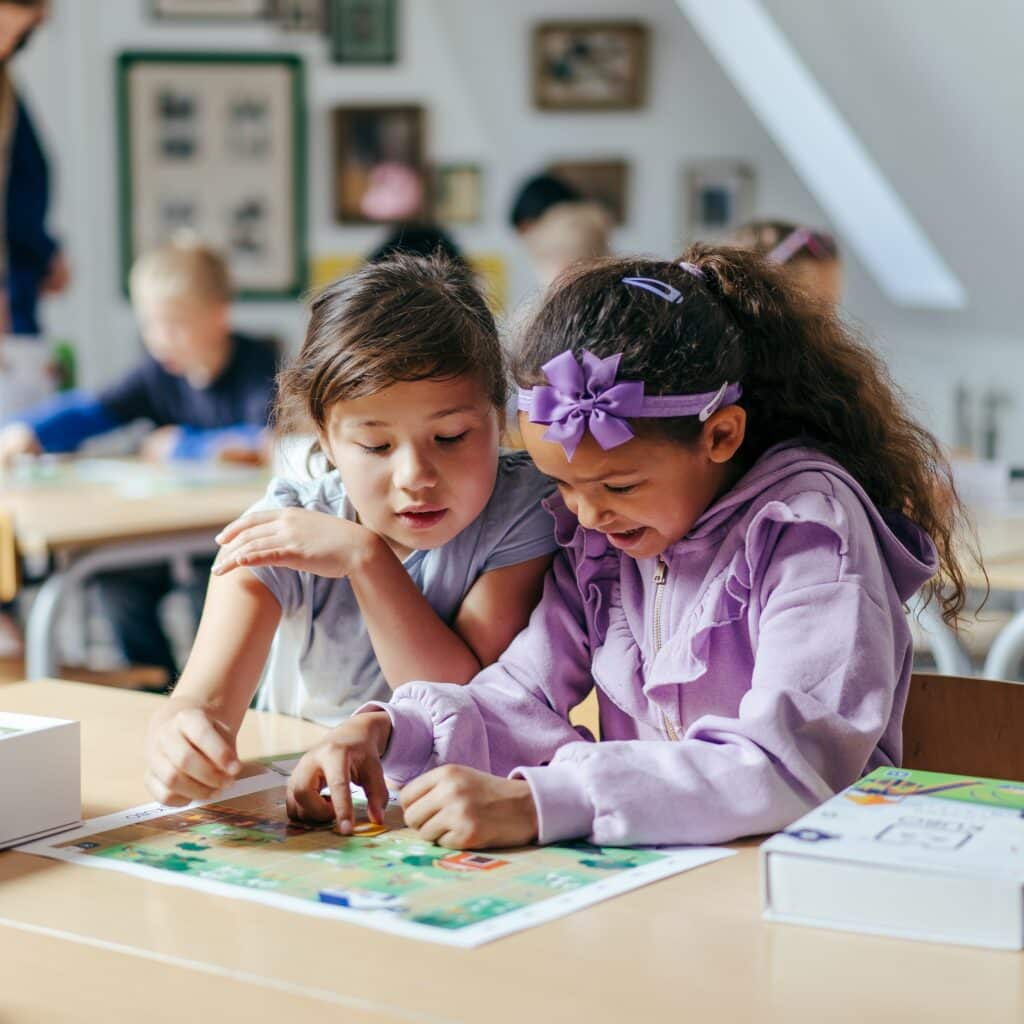 Students coding with KUBO on a themed map